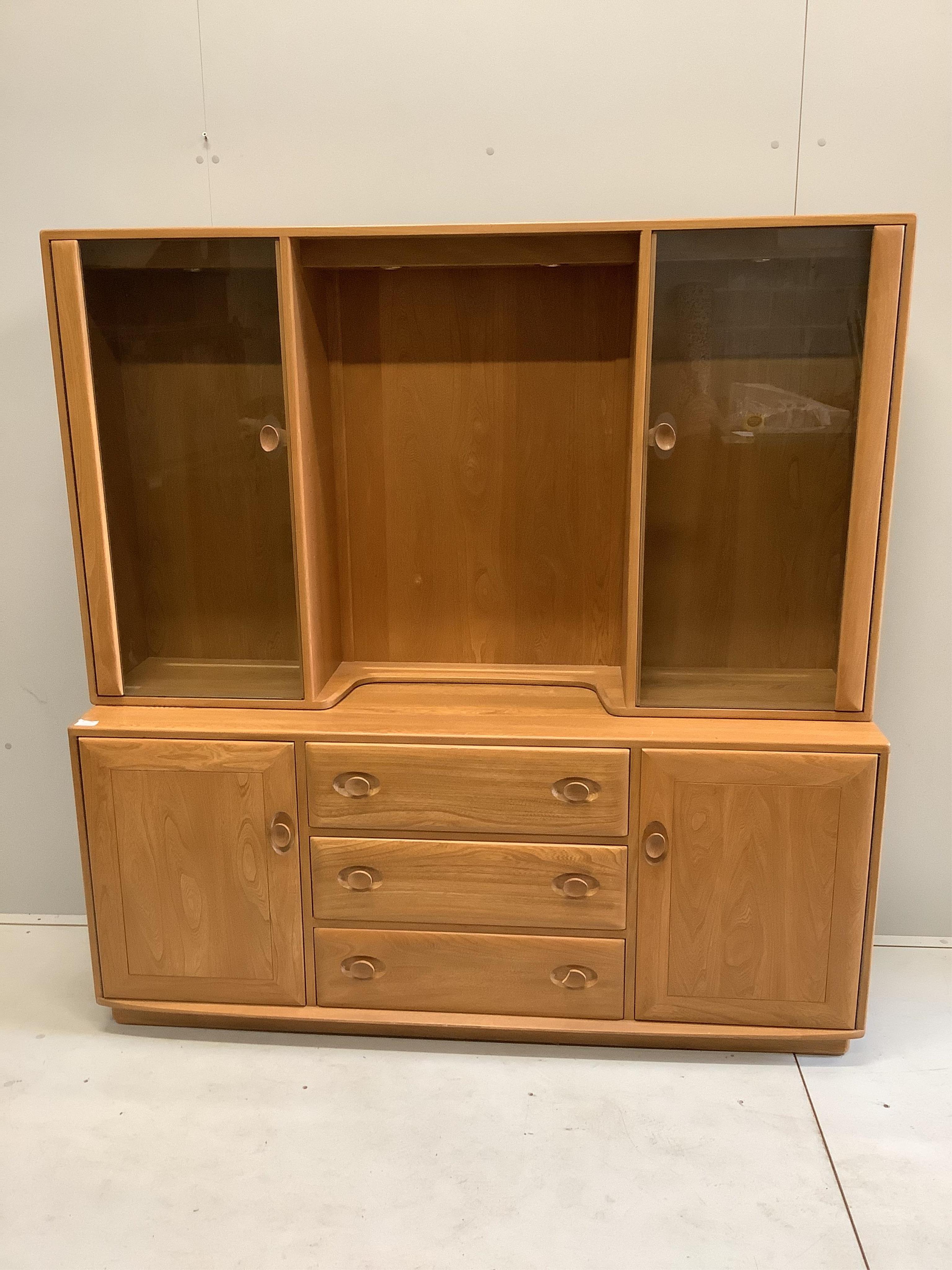 An Ercol Windsor elm sideboard, width 155cm, depth 44cm, height 159cm